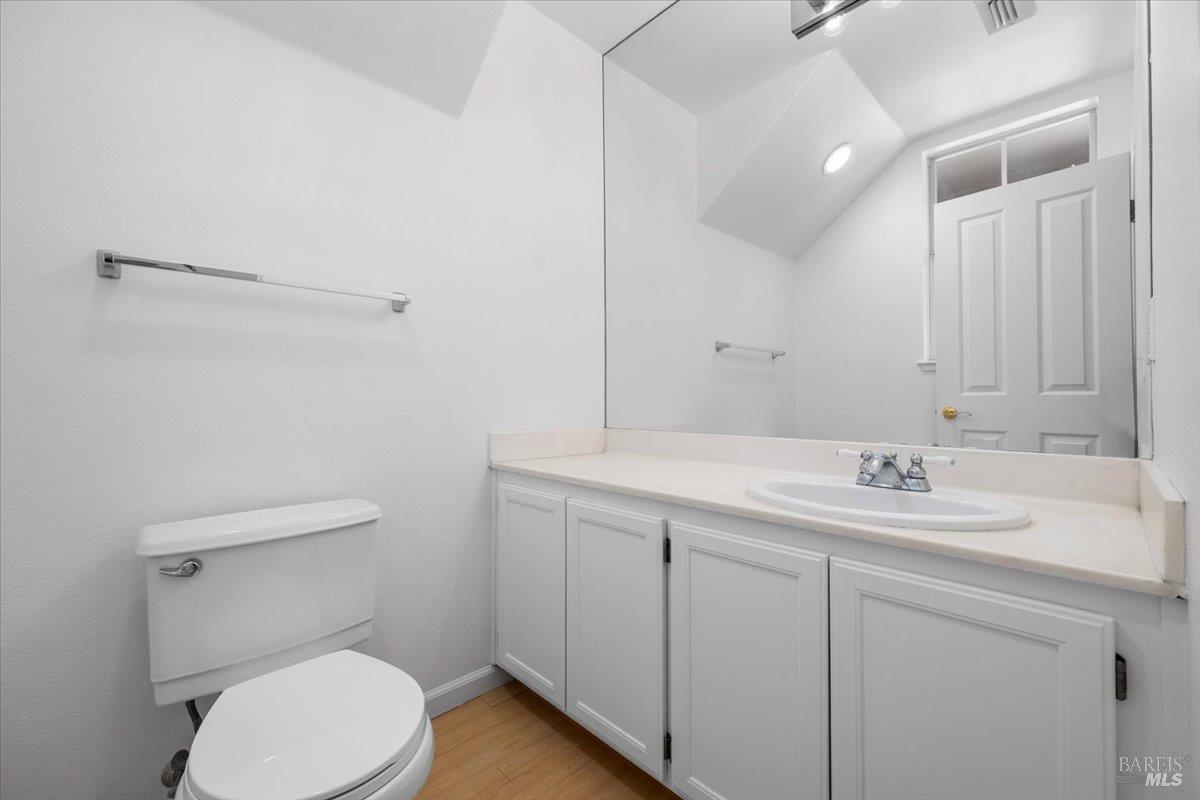 1028 Addison Circle Petaluma, CA 94952 - Photo 21 of 60 a bathroom with a toilet a sink and mirror