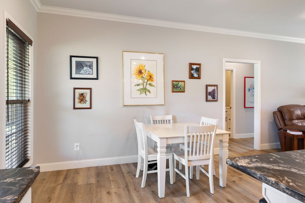 411 Bumpas Road Lawrenceburg, TN 38464 - Photo 11 of 30 a view of a dining room with furniture and wooden floor