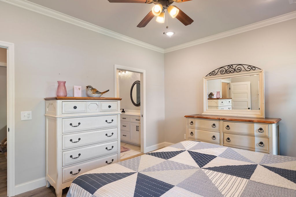 411 Bumpas Road Lawrenceburg, TN 38464 - Photo 14 of 30 a view of a bedroom with furniture and chandelier