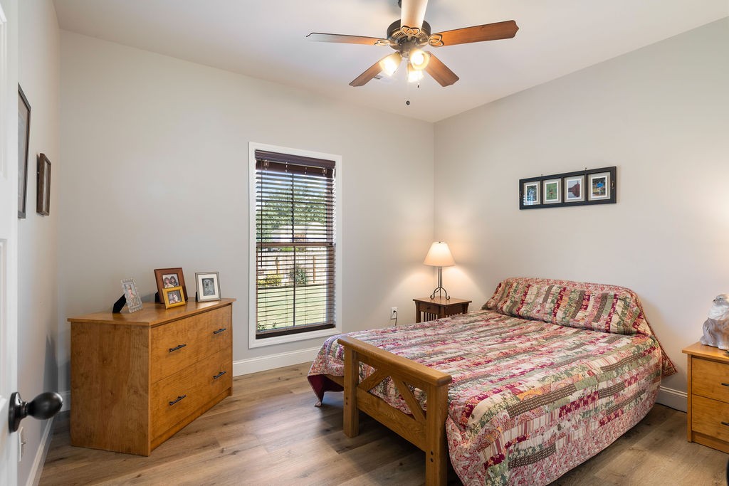 411 Bumpas Road Lawrenceburg, TN 38464 - Photo 17 of 30 a bedroom with a bed and wooden floor