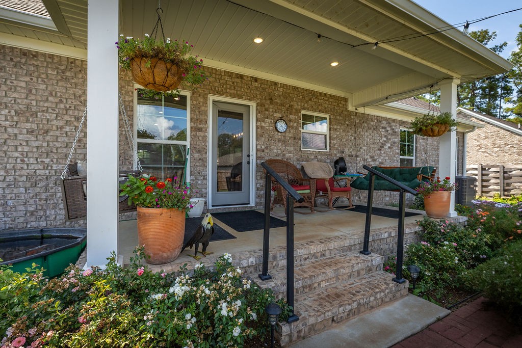 411 Bumpas Road Lawrenceburg, TN 38464 - Photo 22 of 30 a view of a patio with table and chairs potted plants