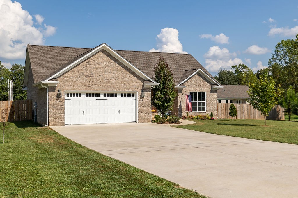 411 Bumpas Road Lawrenceburg, TN 38464 - Photo 3 of 30 a front view of a house with a yard and garage