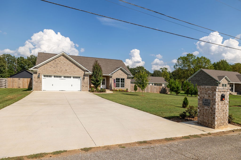 411 Bumpas Road Lawrenceburg, TN 38464 - Photo 5 of 30 a front view of a house with a yard and garage