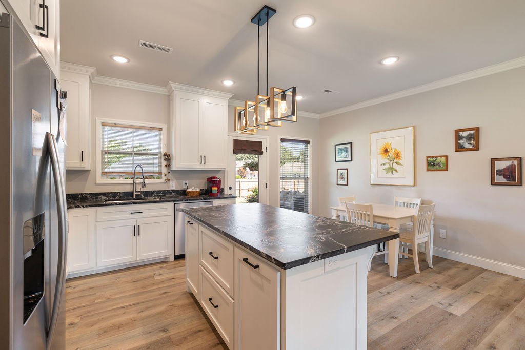 411 Bumpas Road Lawrenceburg, TN 38464 - Photo 8 of 30 a kitchen with kitchen island granite countertop a sink cabinets and refrigerator