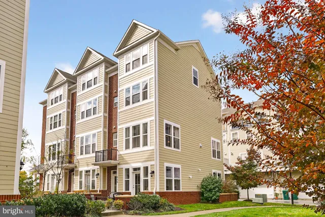 a front view of a residential apartment building with a yard