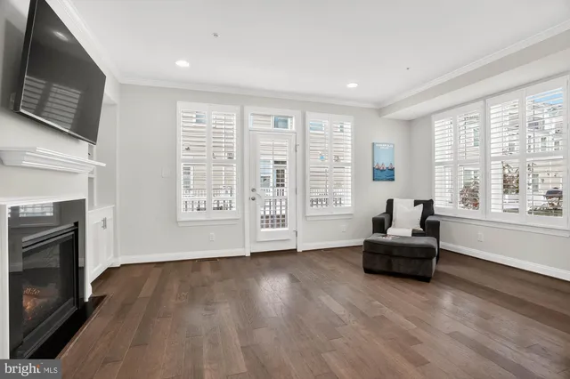 a kitchen with stainless steel appliances a dining table chairs refrigerator and microwave