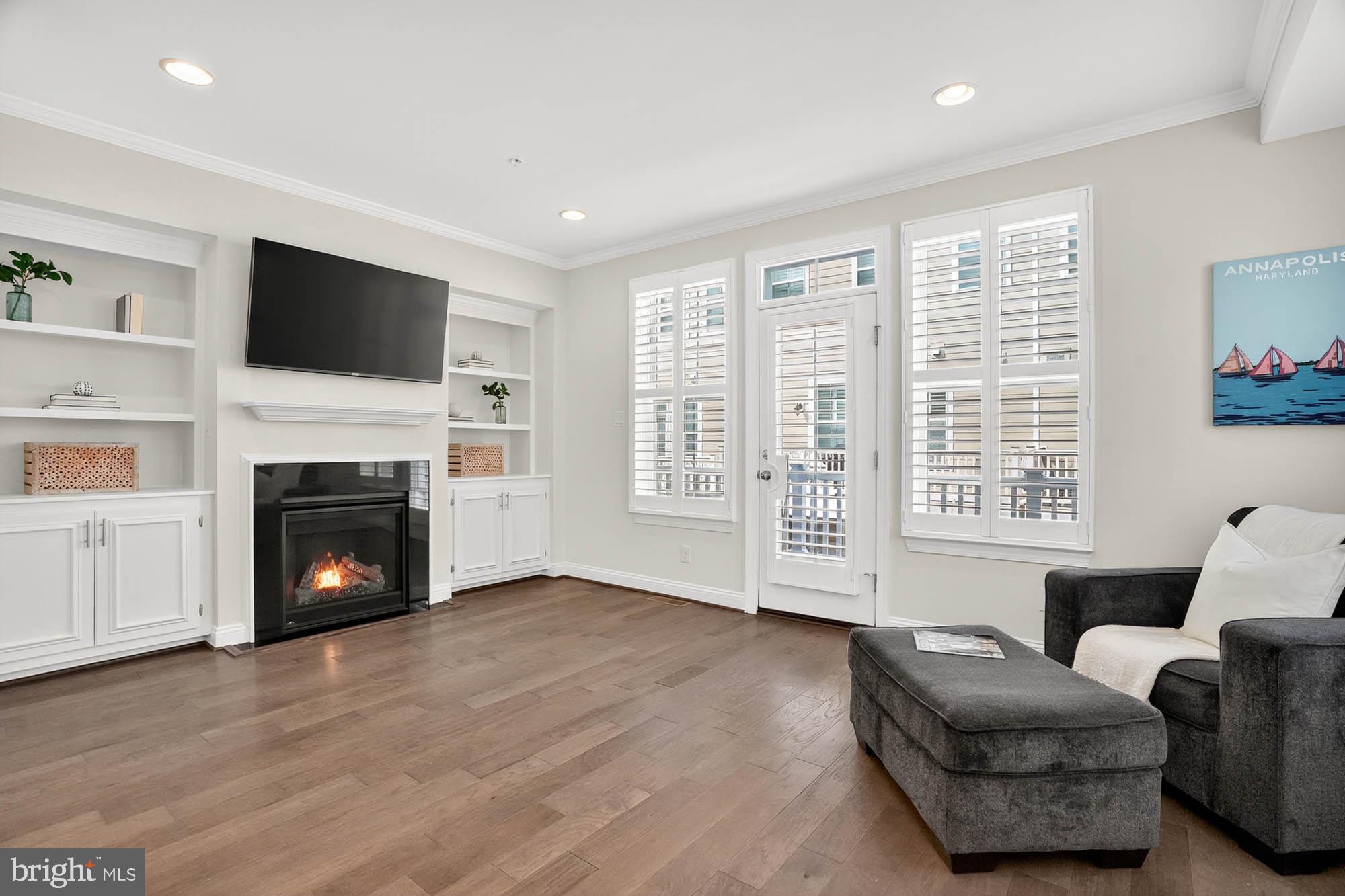 606 James Walker Place Annapolis, MD 21401 - Photo 13 of 52 a living room with furniture a flat screen tv and a fireplace