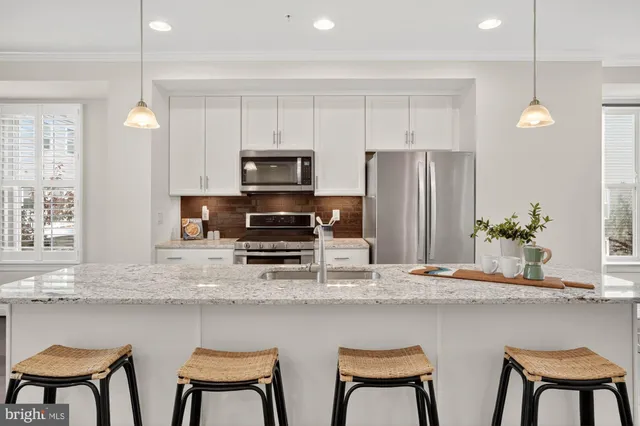 a bathroom with a granite countertop sink a mirror and a shower