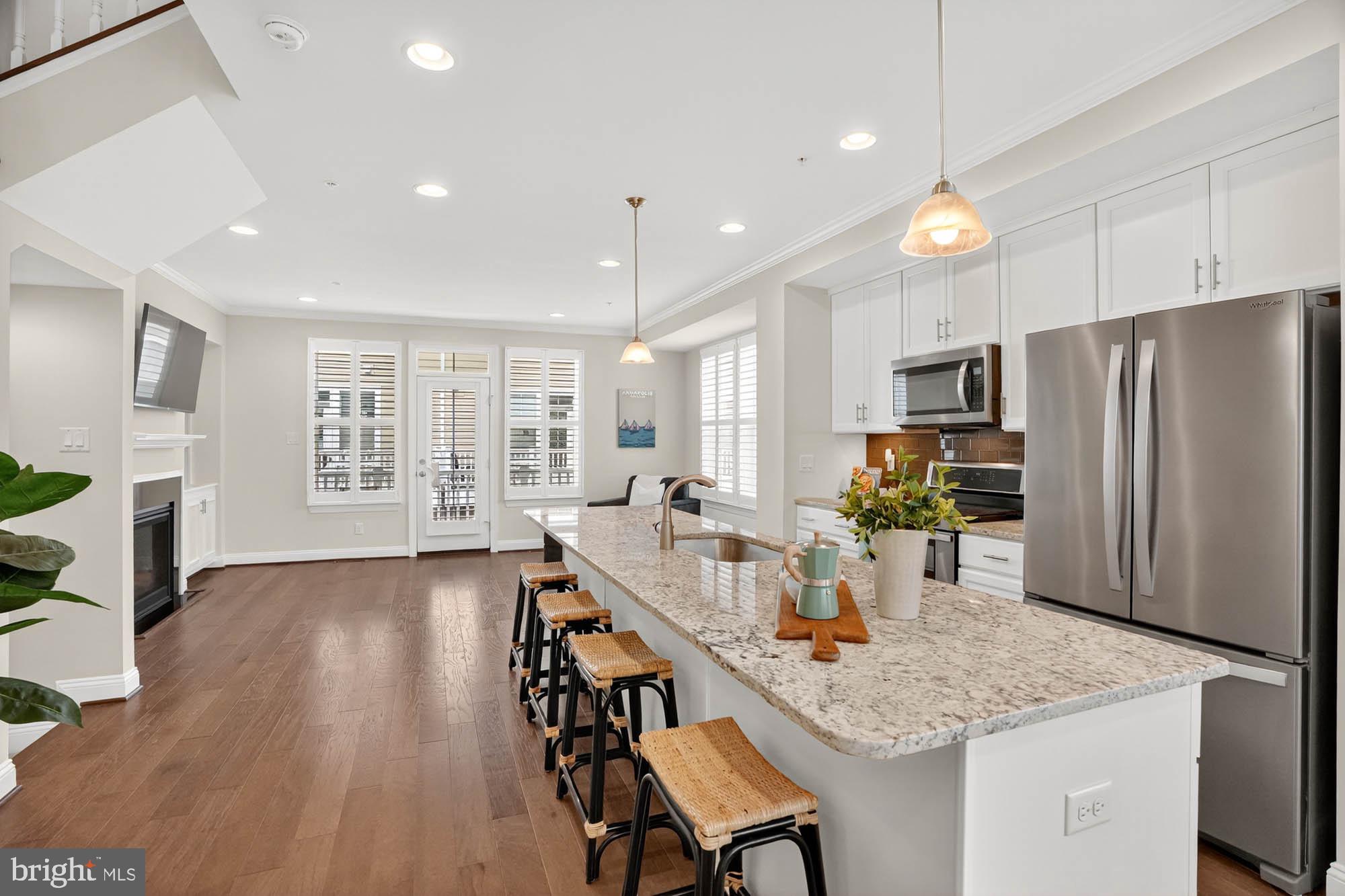606 James Walker Place Annapolis, MD 21401 - Photo 20 of 52 a kitchen with stainless steel appliances granite countertop sink refrigerator dining table and chairs