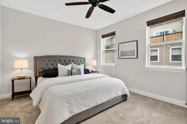 a front view of a multi story residential apartment building with a yard