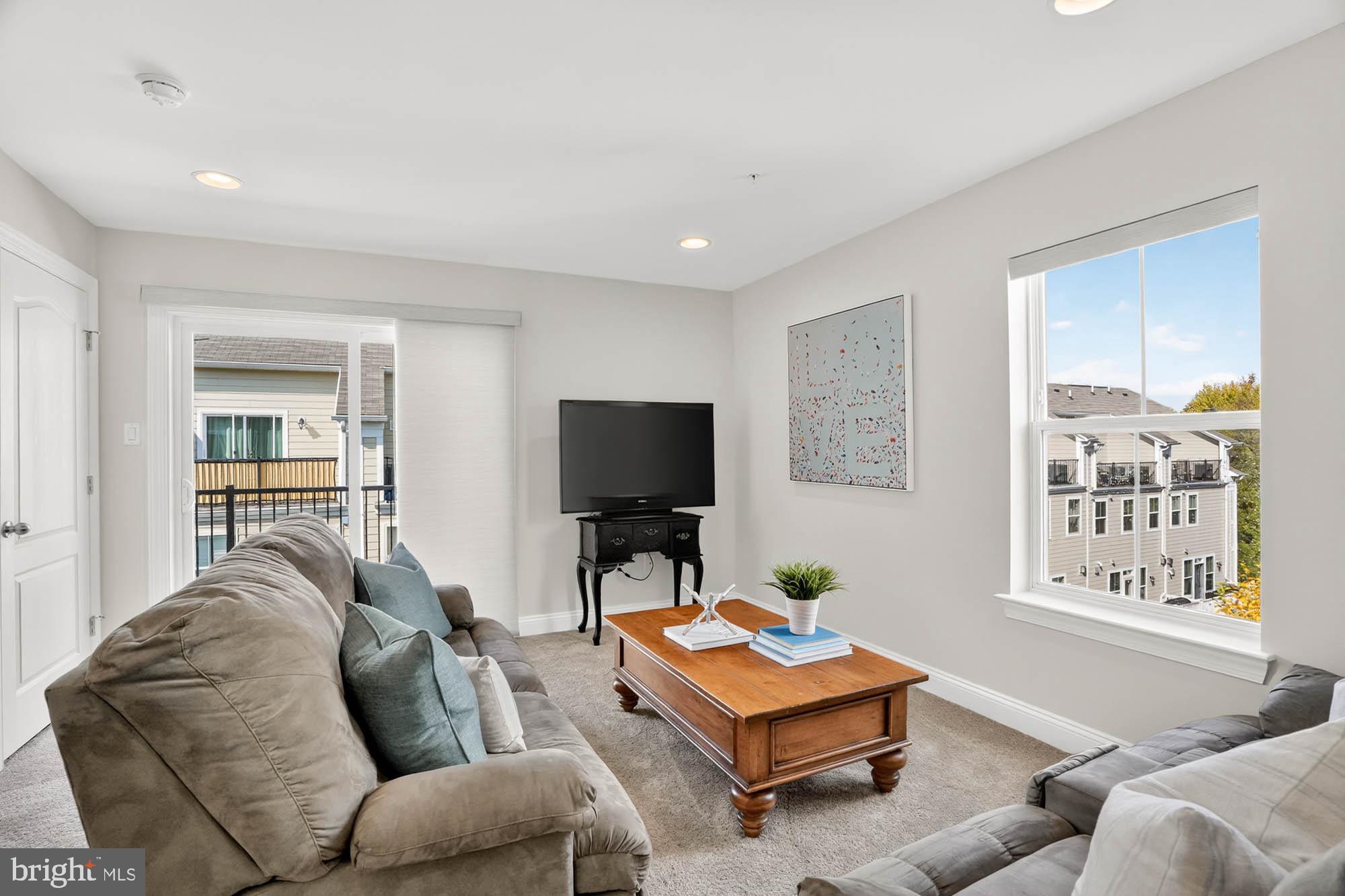 606 James Walker Place Annapolis, MD 21401 - Photo 38 of 52 a living room with furniture a window and a flat screen tv
