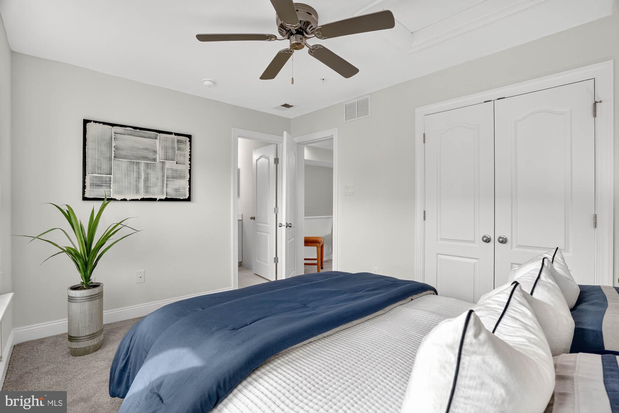 606 James Walker Place Annapolis, MD 21401 - Photo 40 of 52 a bedroom with a bed and a chandelier