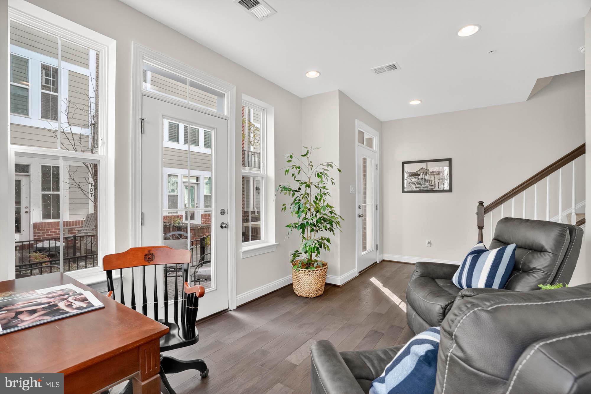 606 James Walker Place Annapolis, MD 21401 - Photo 9 of 52 a living room with furniture stairs and a potted plant