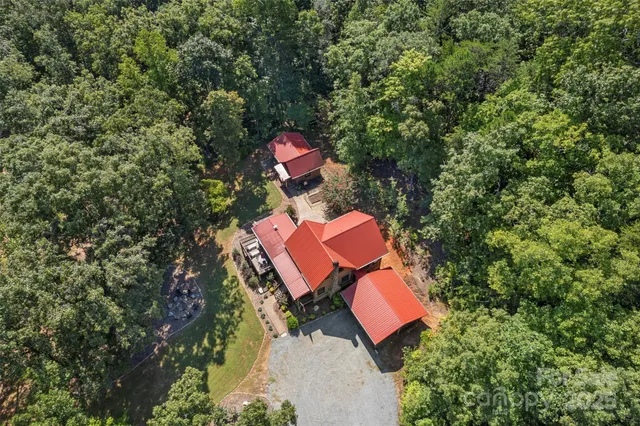 a bedroom with a bed a mirror and a large window