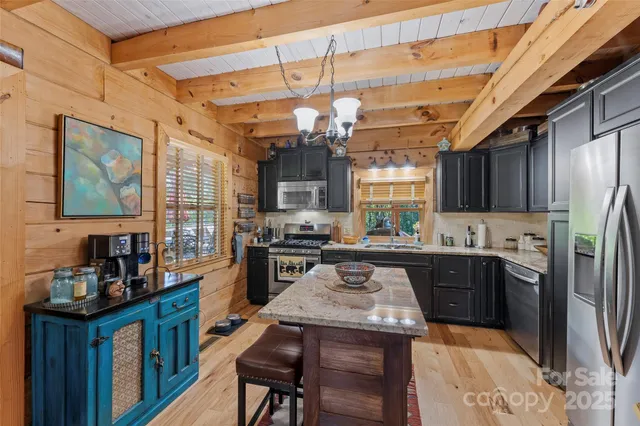 a kitchen with stainless steel appliances granite countertop a stove refrigerator and cabinets