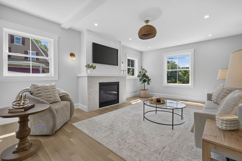 20 Saltonstall Road Medford, MA 02155 - Photo 4 of 41 a living room with furniture a flat screen tv and a fireplace