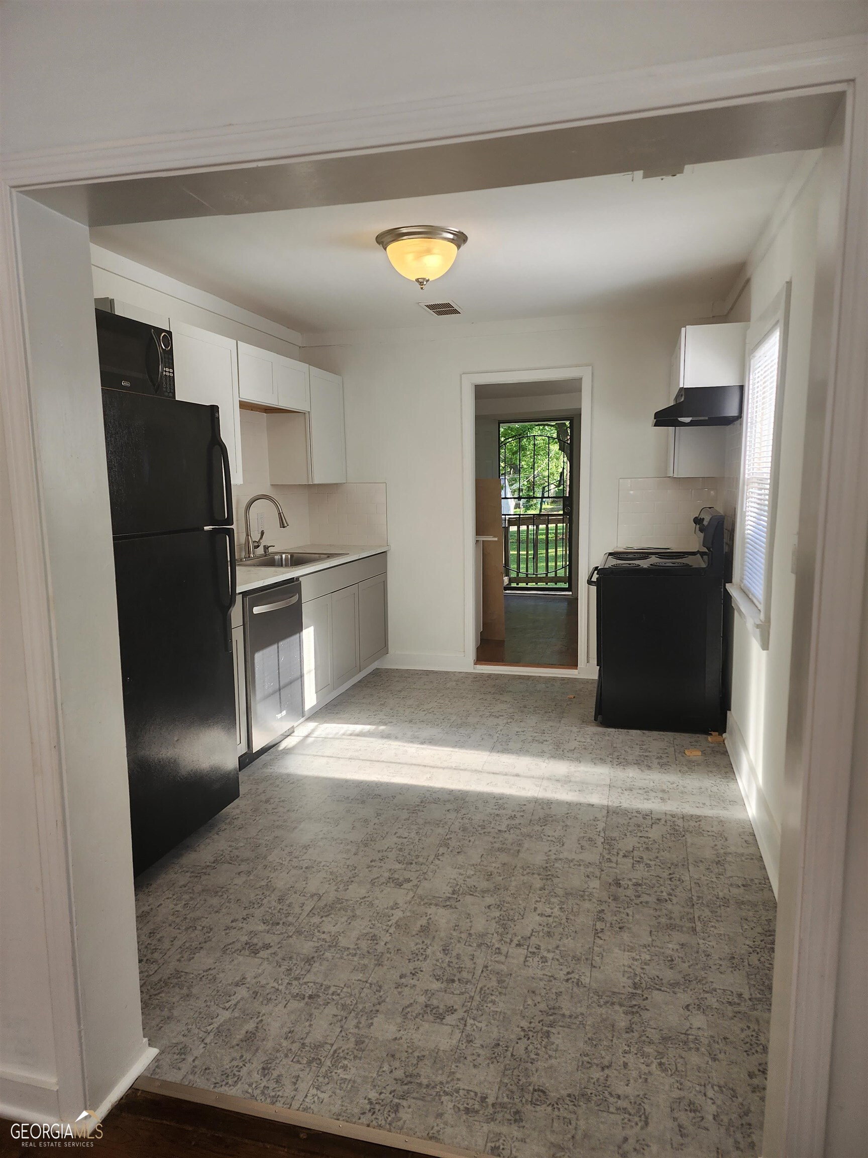 2577 Eastwood Drive Decatur, GA 30032 - Photo 5 of 21 a kitchen with granite countertop a refrigerator and a stove