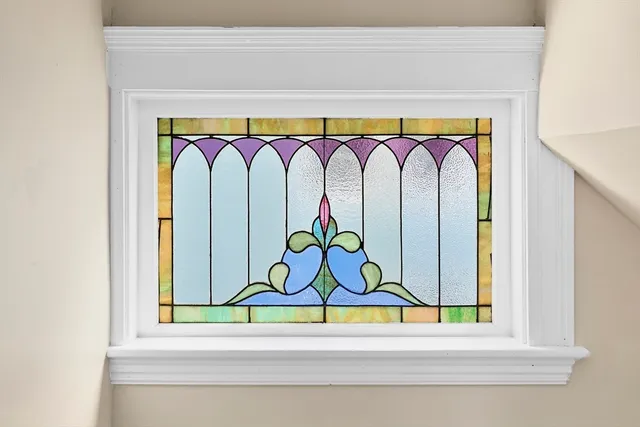 a room with a bench and a painting on the wall