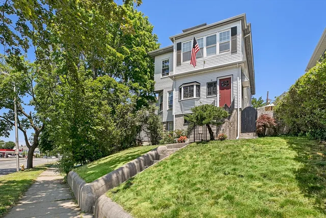 a view of house with a yard