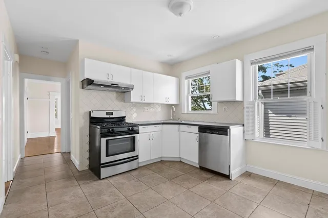 a kitchen with a stove top oven and cabinets