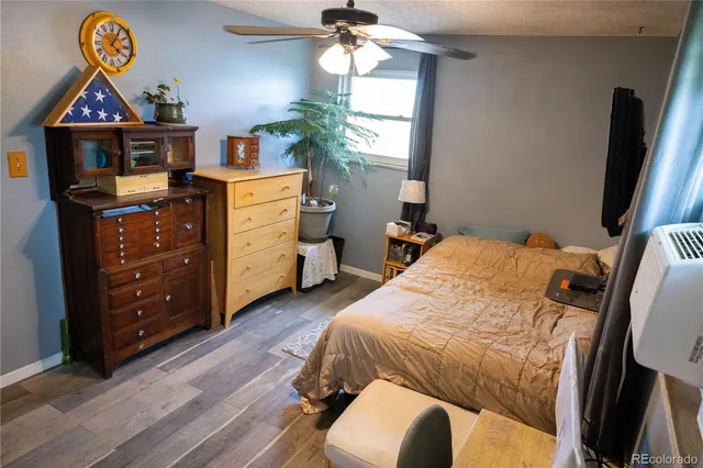 a bedroom with a bed and a flat tv screen on dresser