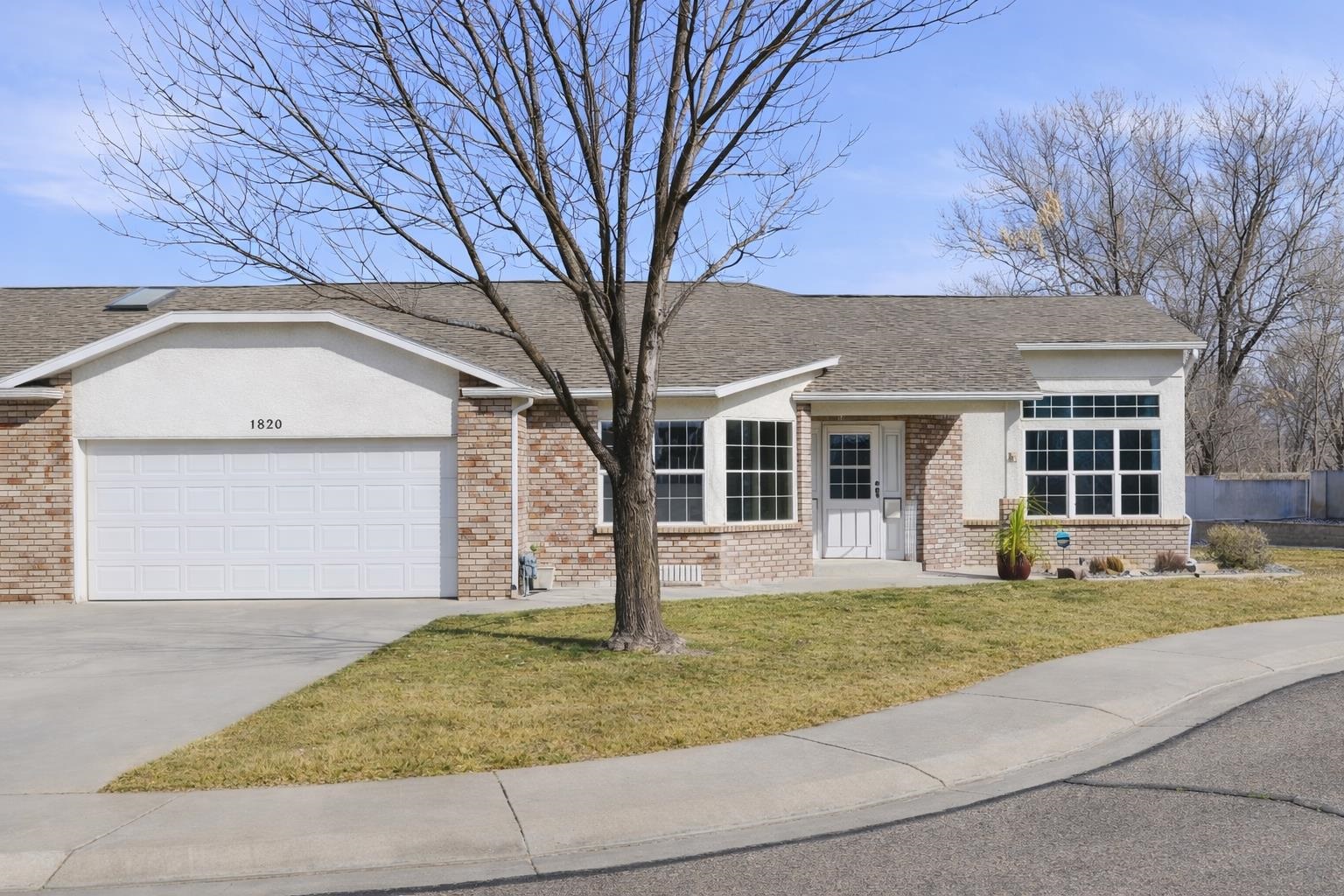 1820 Bittern Court Grand Junction, CO 81506 - Photo 1 of 28 a front view of a house with a yard and garage