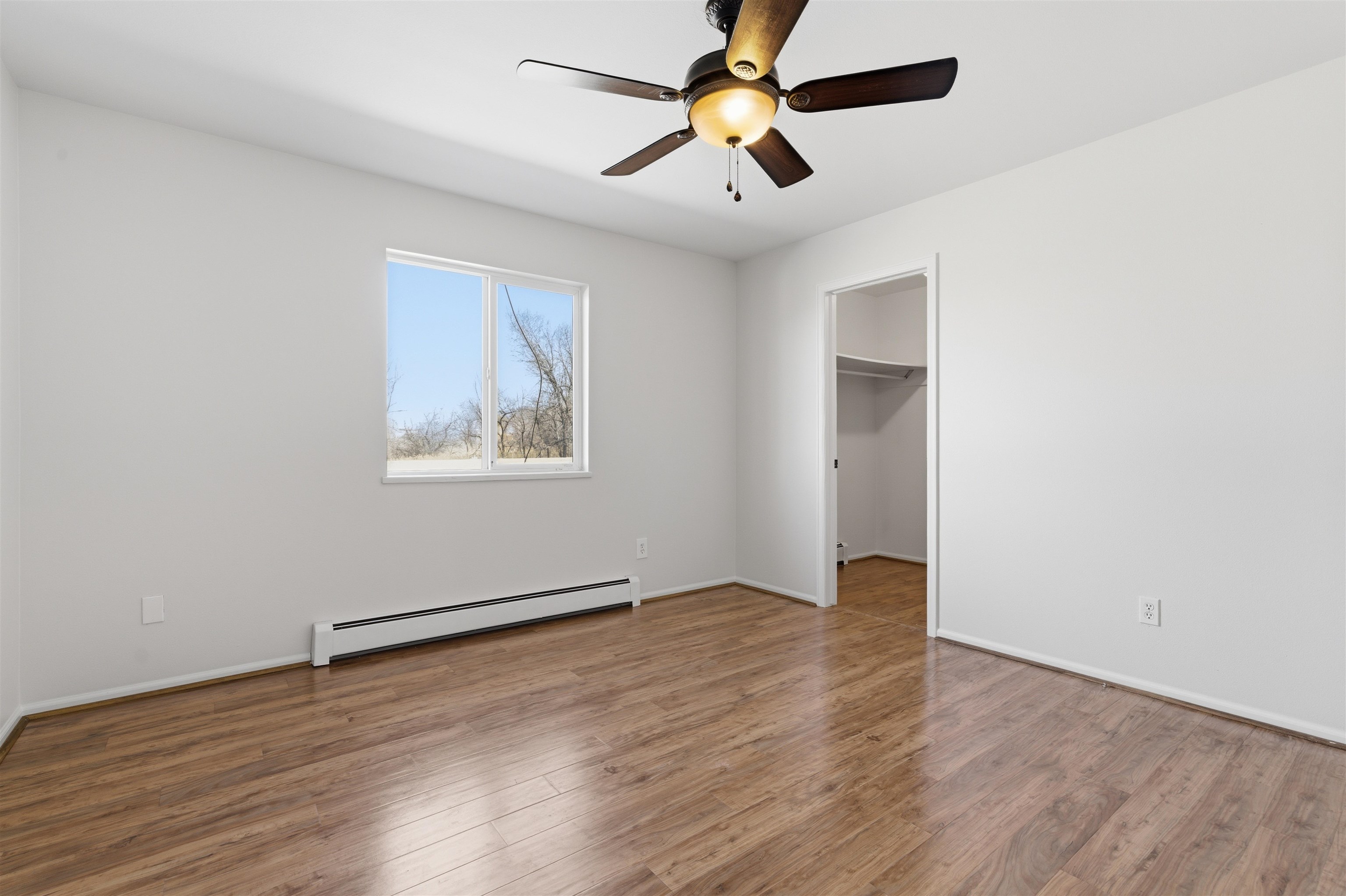 1820 Bittern Court Grand Junction, CO 81506 - Photo 16 of 28 an empty room with wooden floor chandelier fan and windows