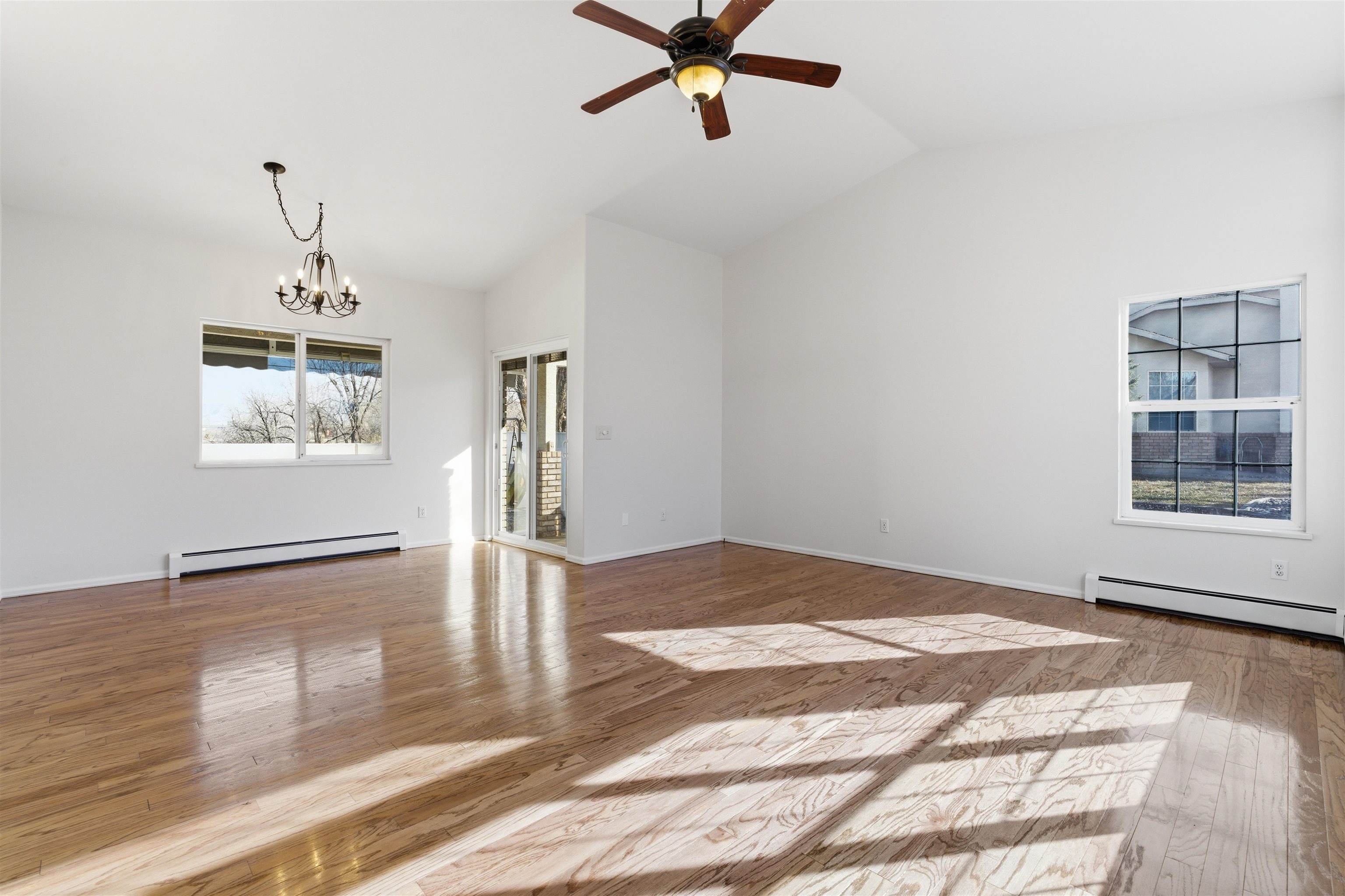 1820 Bittern Court Grand Junction, CO 81506 - Photo 3 of 28 a view of a livingroom with wooden floor and a ceiling fan