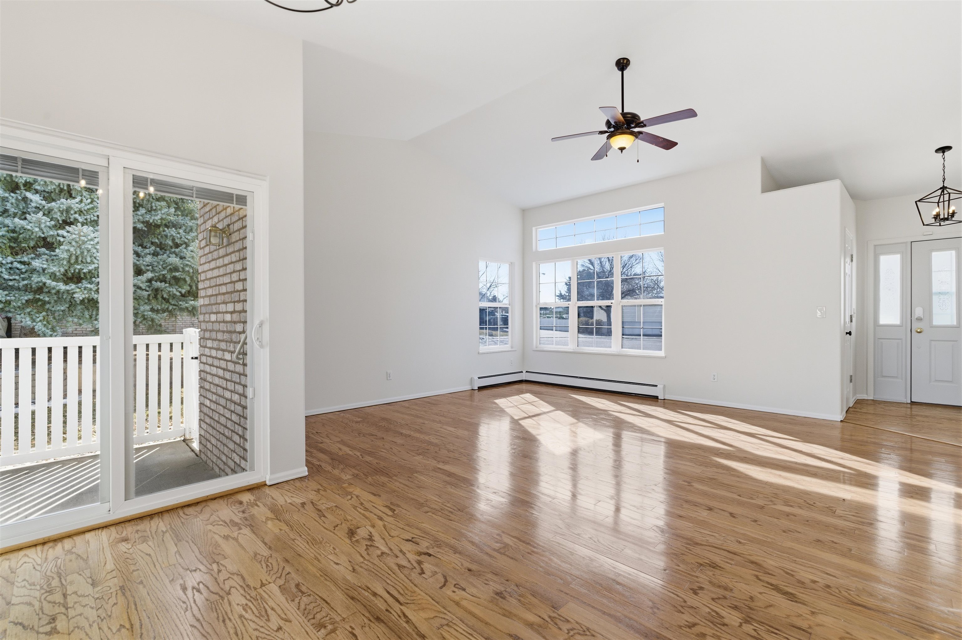 1820 Bittern Court Grand Junction, CO 81506 - Photo 5 of 28 a view of an empty room with wooden floor fireplace and a window