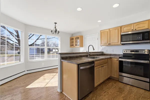 a kitchen with stainless steel appliances granite countertop a stove and a sink