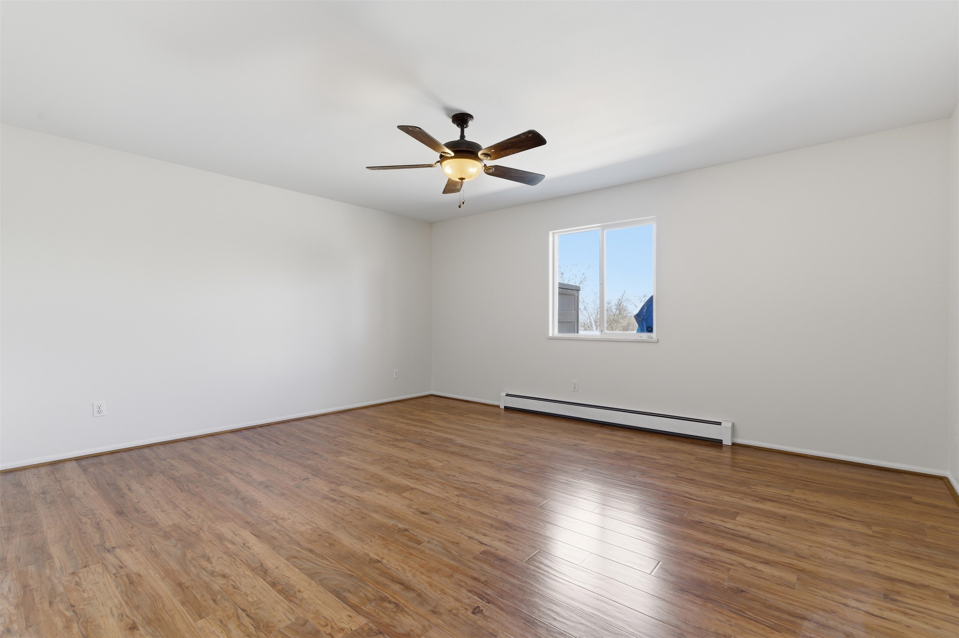 1820 Bittern Court Grand Junction, CO 81506 - Photo 10 of 28 an empty room with wooden floor chandelier fan and windows