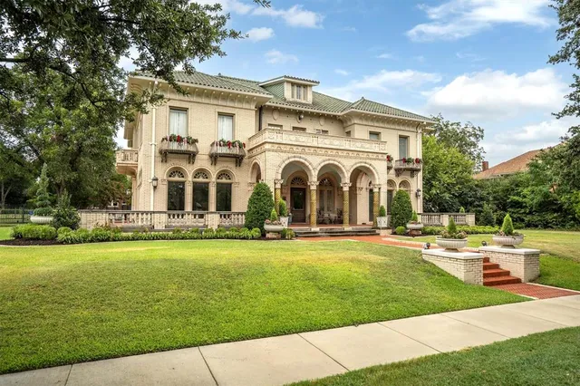a front view of a house with swimming pool having outdoor seating