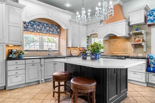 a view of staircase with lots of frames on wall and windows