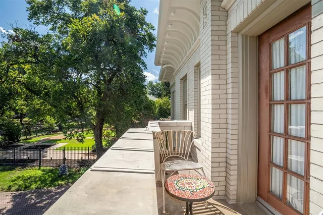 a spacious bedroom with a bed and a chandelier