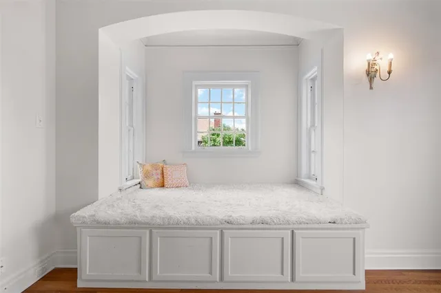 a view of a hallway with windows and chandelier