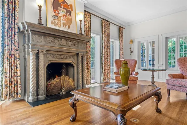 a bedroom with furniture and a large window