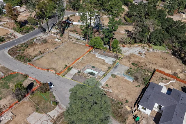 an aerial view of a house with a yard and lake view