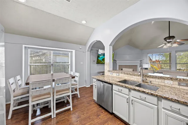 a kitchen with a sink and chairs