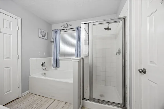 a bathroom with a bathtub and shower