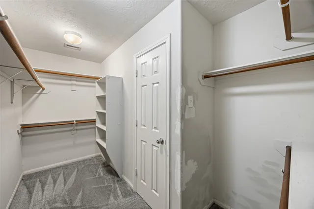 a view of a hallway with a white walls