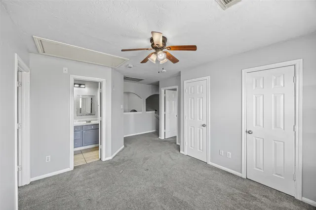 a view of a room with cabinet and a ceiling fan