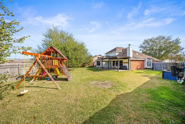 a view of a house with a yard and sitting area