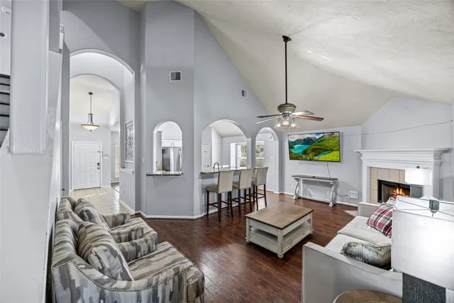 a living room with furniture fireplace and wooden floor