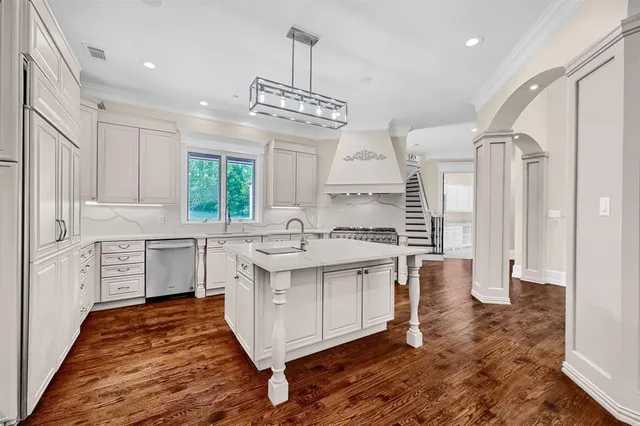 a kitchen with a stove a sink and a refrigerator