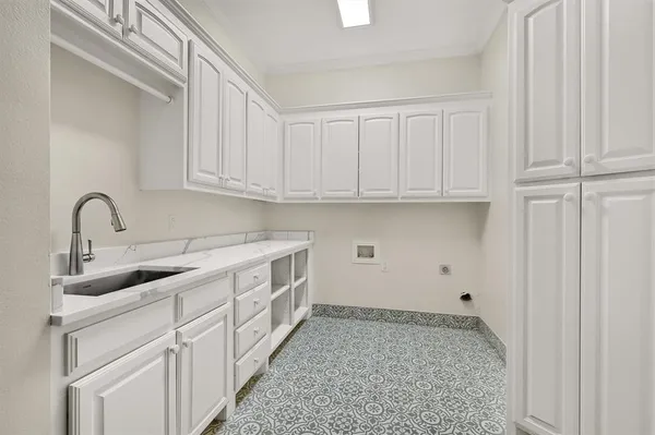 a spacious en suite bathroom with a double vanity sink a mirror and a bathtub