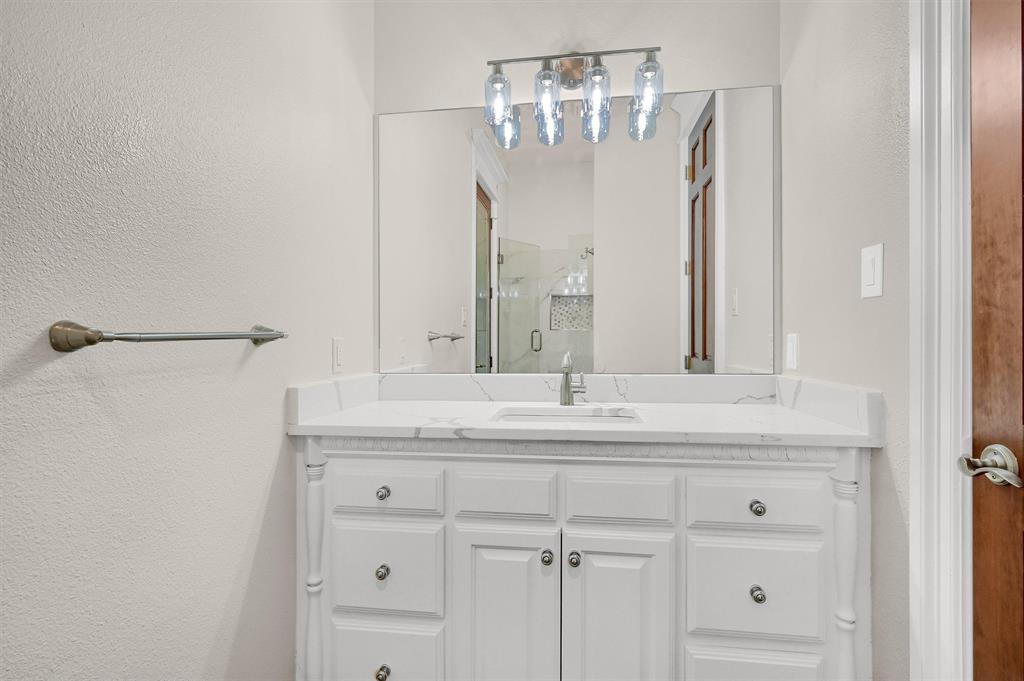2910 Wellington Drive Sherman, TX 75092 - Photo 24 of 40 a bathroom with a granite countertop sink and a mirror