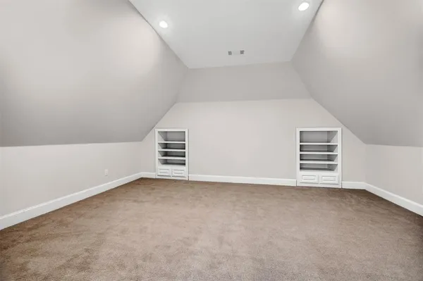 an empty room with a ceiling fan and windows
