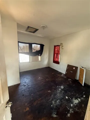 a bed sitting in a bedroom next to a window