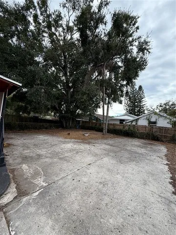 a view of backyard with large trees