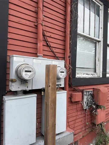 a view of a livingroom with a piano and wooden floor